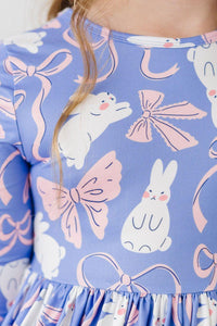 close-up of girls twirl dress with pockets in purple featuring white bunny and pink bow print