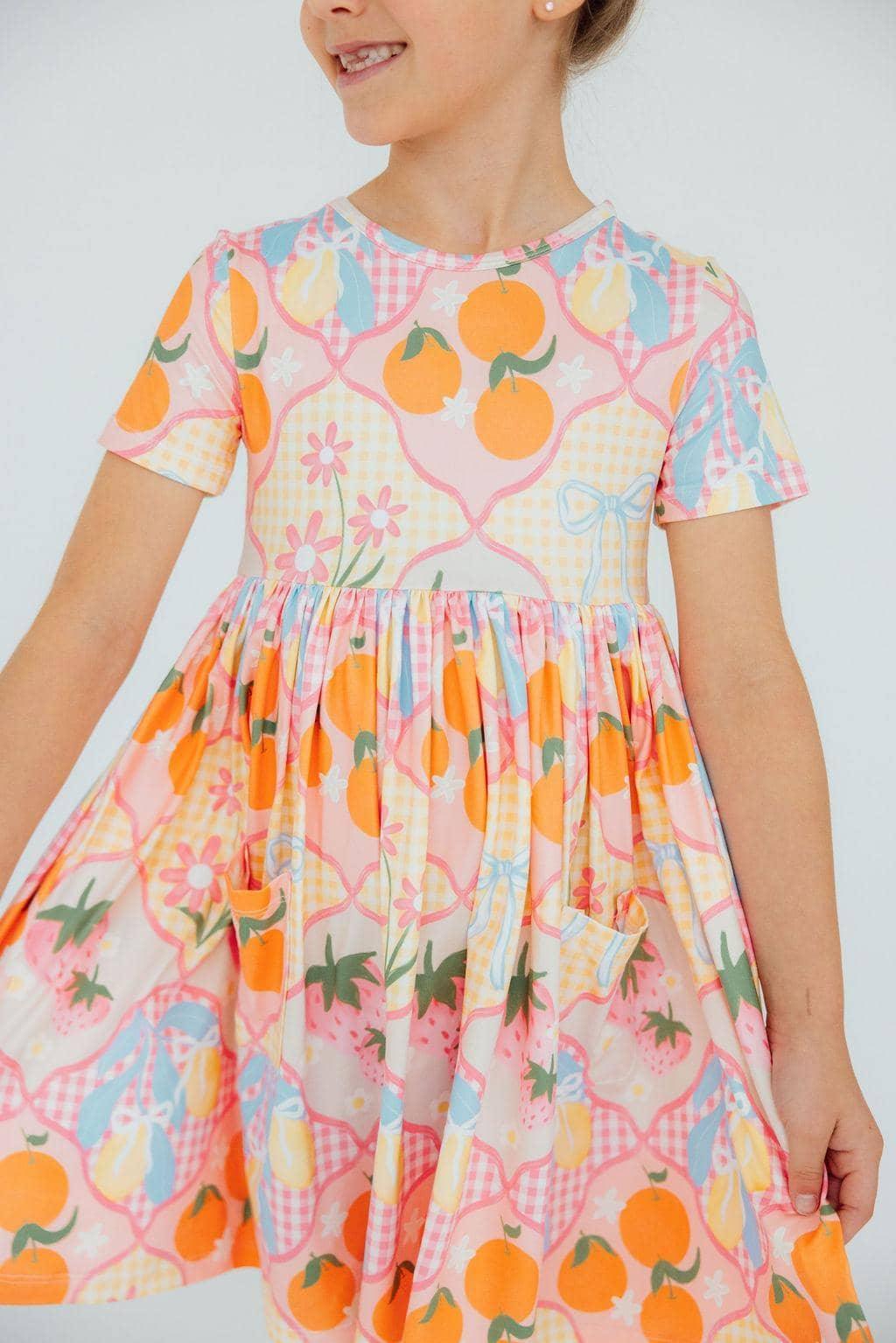 Girls short sleeve twirl pocket dress with colorful fruit and floral pattern for kids