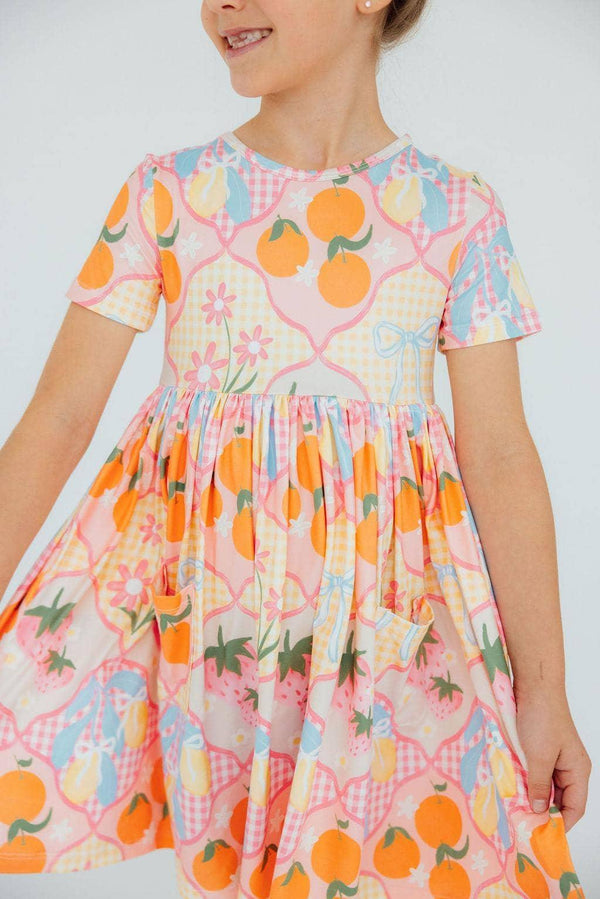 Girls short sleeve twirl pocket dress with colorful fruit and floral pattern for kids