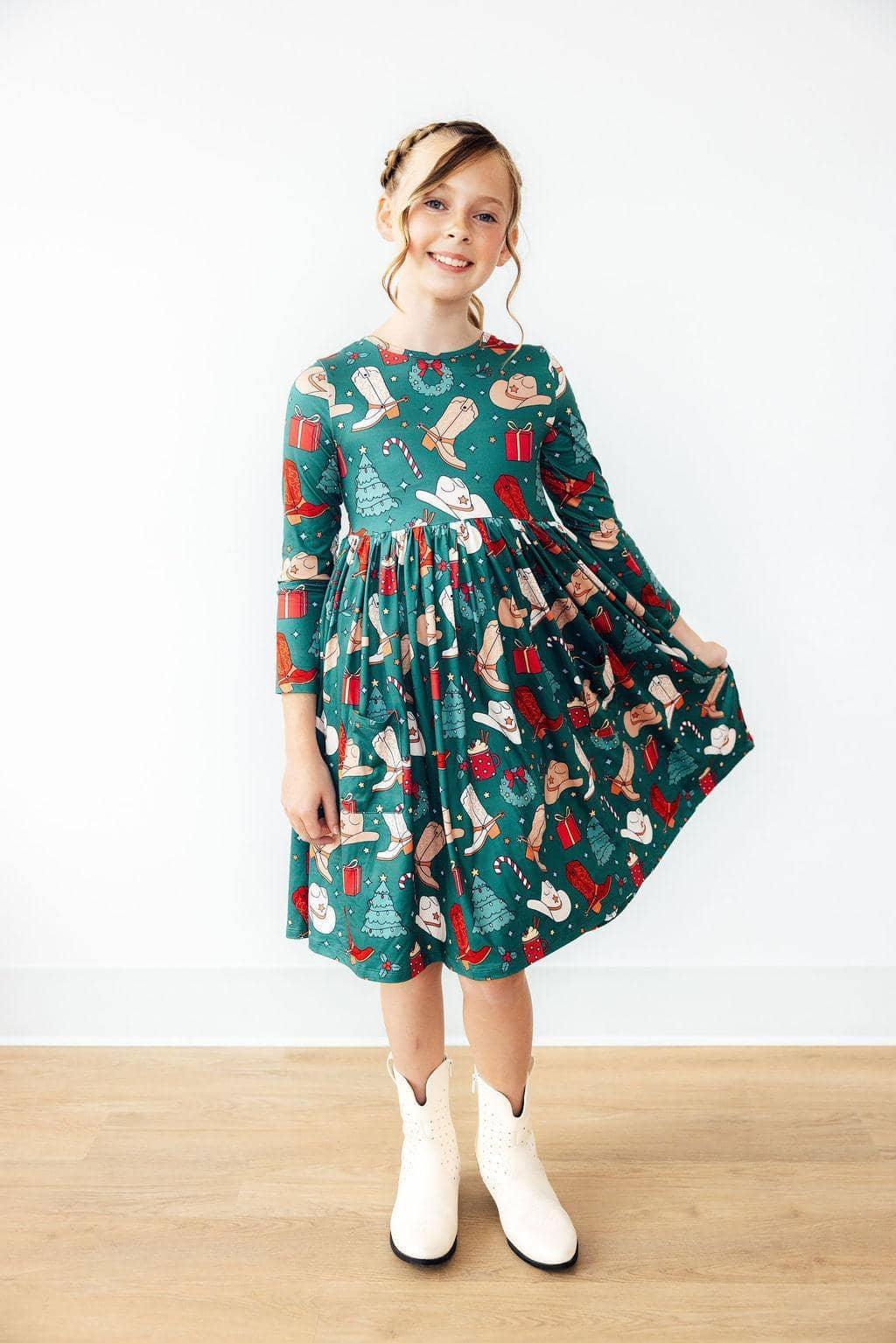 Girls green western themed twirl dress with long sleeves and pockets, holiday print for kids