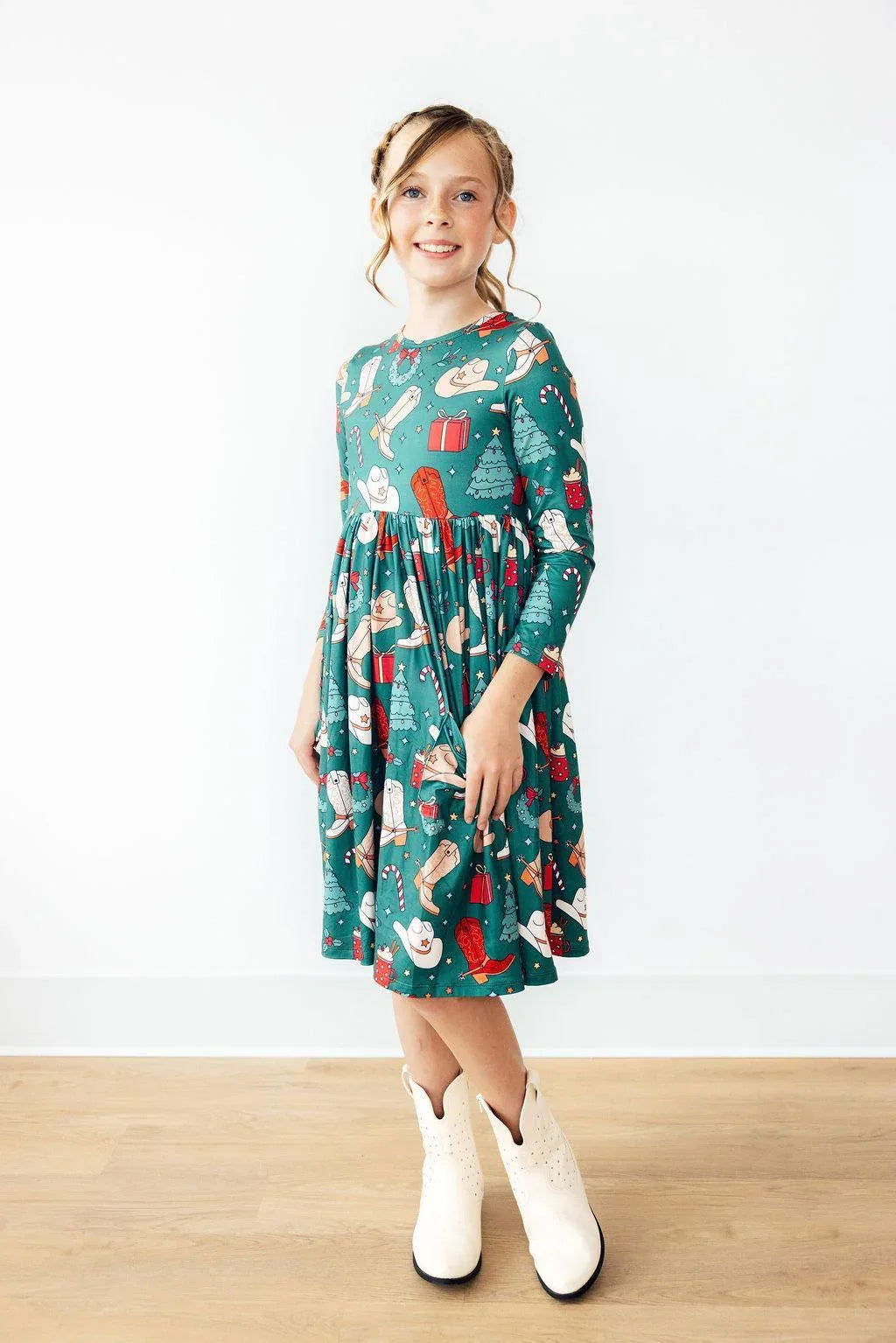 Girls green long sleeve twirl dress with Christmas western themed print and pockets for kids