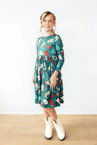Girls green long sleeve twirl dress with Christmas western themed print and pockets for kids