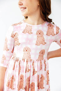 girl wearing pink goldendoodle twirl dress for girls with 3/4 sleeves smiling and posing