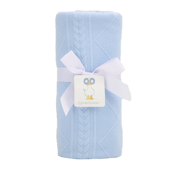 blue knit baby blanket rolled and tied with white ribbon suitable for newborns