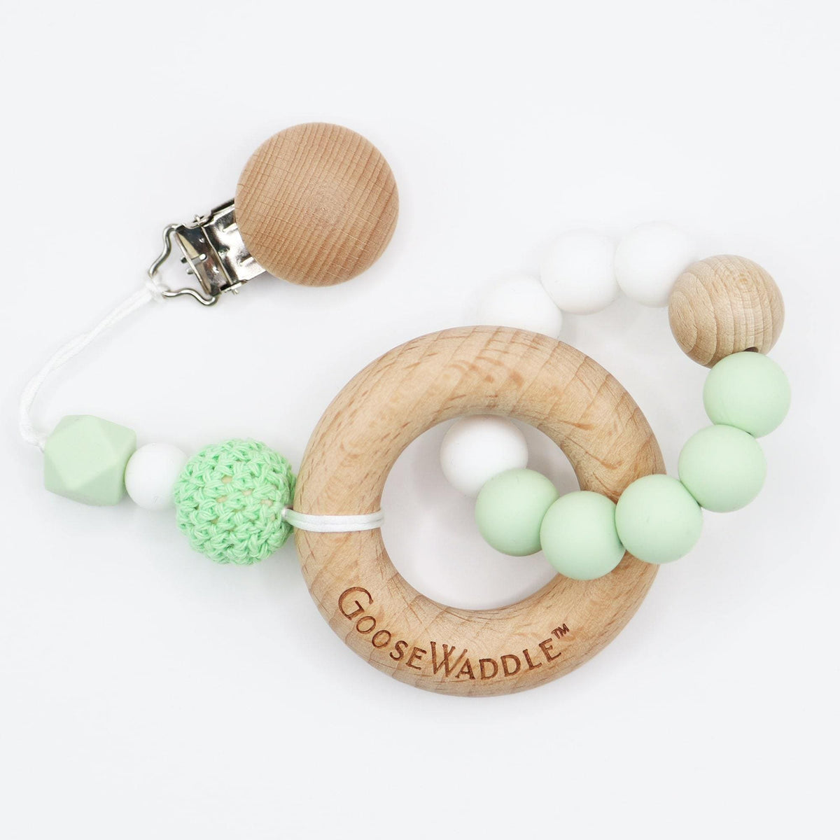Goosewaddle gift set featuring a newborn wooden teether ring with pastel green and white beads