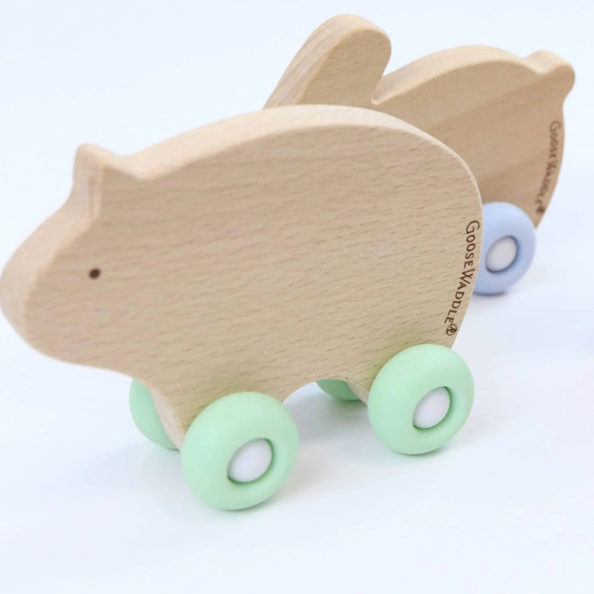 Natural wood silicone wood baby teether in animal shape with pastel green and blue silicone wheels