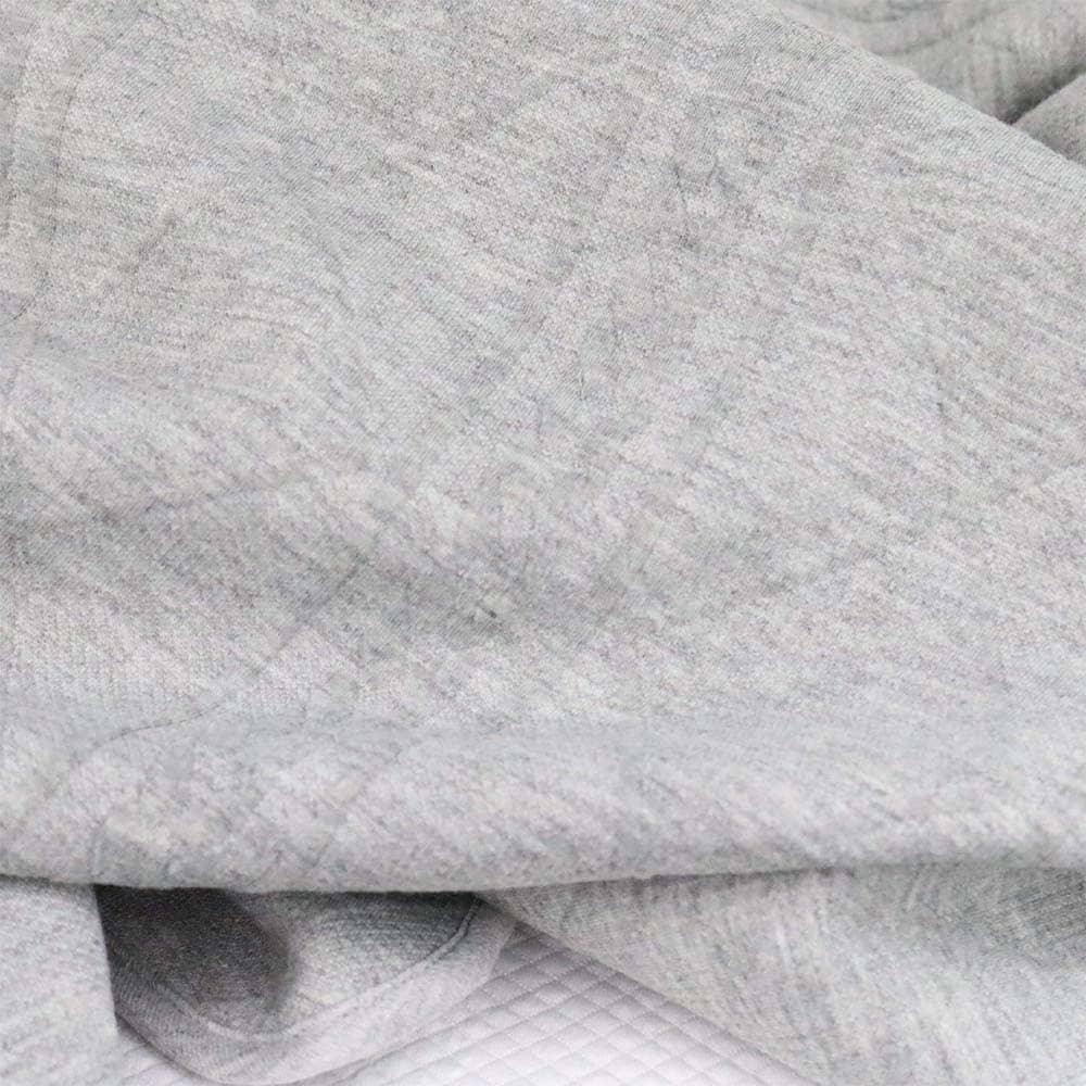 Soft gray knit baby blanket draped for newborns showing cozy texture and gentle fabric