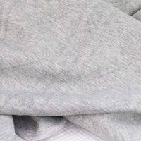 Soft gray knit baby blanket draped for newborns showing cozy texture and gentle fabric