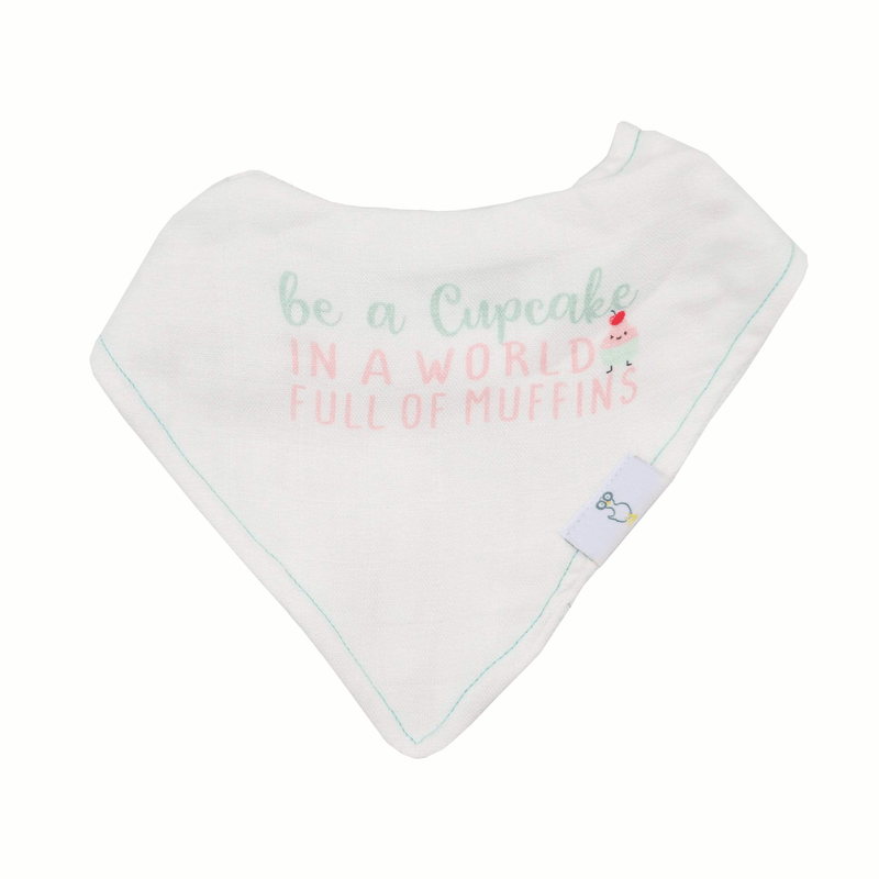 Single bib from the Muffin and Cupcake 2 Pack Muslin & Terry Cloth Bib Set displaying the uplifting quote 'be a Cupcake in a world full of muffins' with playful cupcake graphics.