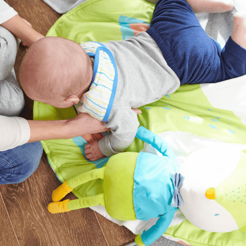 Baby playing on the Fox Stroller Blanket, highlighting its cozy design and vibrant colors with a plush toy.