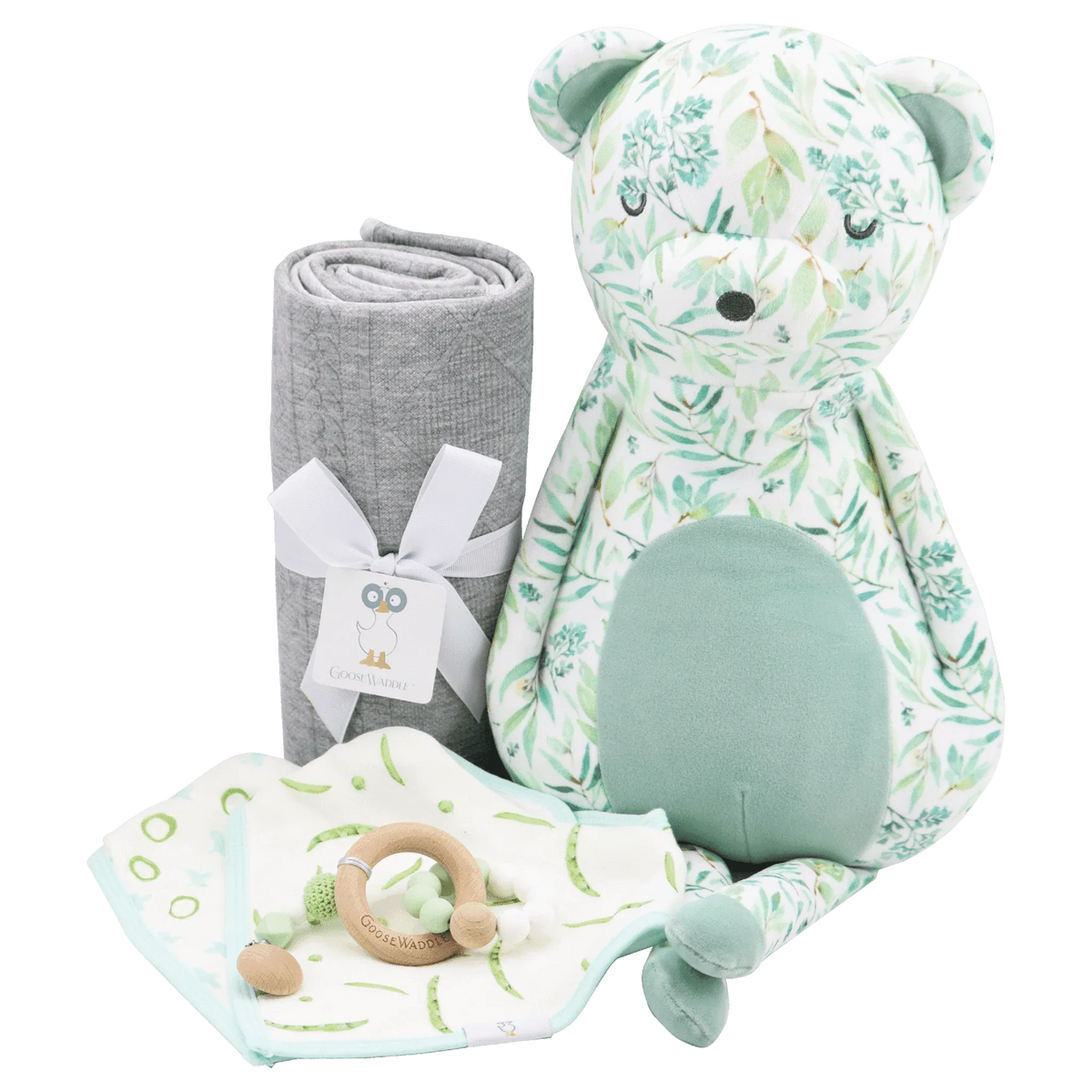 mint plush bear for babies sitting next to gray rolled blanket and teething ring on white background