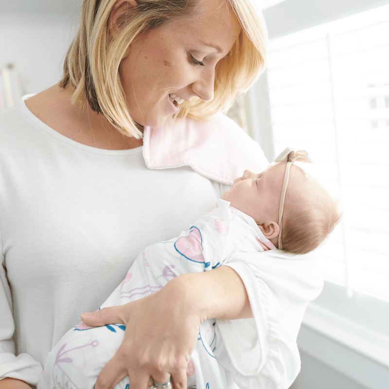 2 PK Newborn Receiving Blankets: A happy moment between a mother and her baby, showcasing the soft, cozy feel of the blankets by Goosewaddle, ideal for swaddling and nurturing.