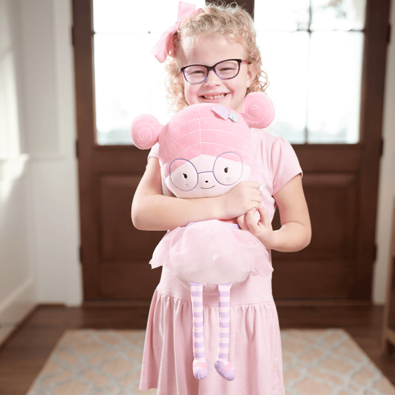 A smiling girl holding the Meg Fairy Plush Doll with Dress and Wings, depicting the doll's charm as a beloved companion.