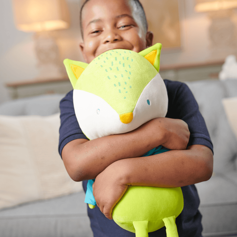 Child hugging the Tripp Fox Plush Doll with Shirt/Bow Tie for Babies, emphasizing the doll's huggable design and appeal for young kids.