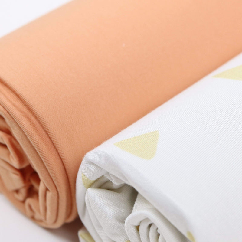 Close-up of the Tan Triangle and Terra Cotta 2 PK Swaddle Blanket set by Goosewaddle®, highlighting the soft touch and contemporary design.