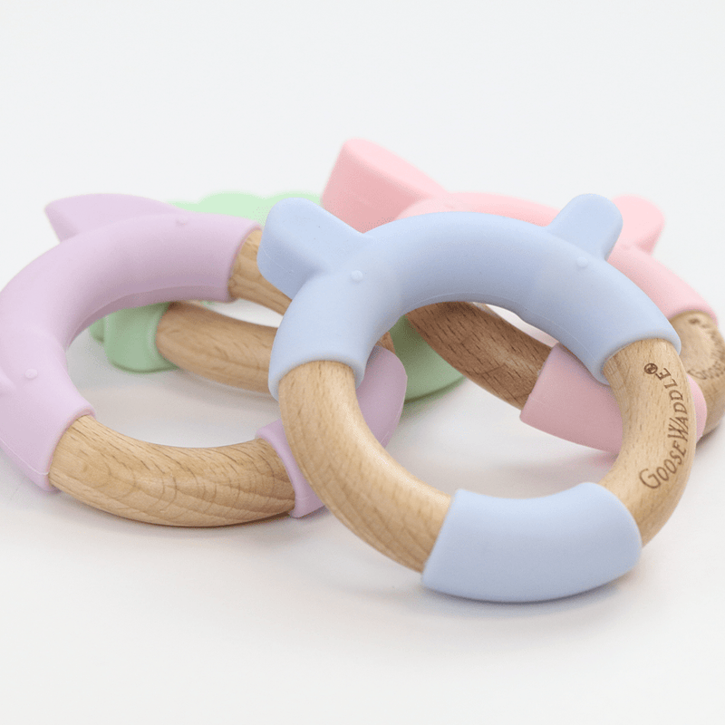 Collection of colorful Blue Bear Circle Bear Head Teether Silicone + Wood Teethers, emphasizing their playful designs and safe materials for infants.