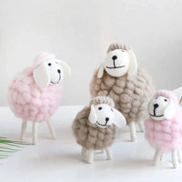 Handmade sheep nursery decor in pink and beige for kids and babies, soft textured wool design