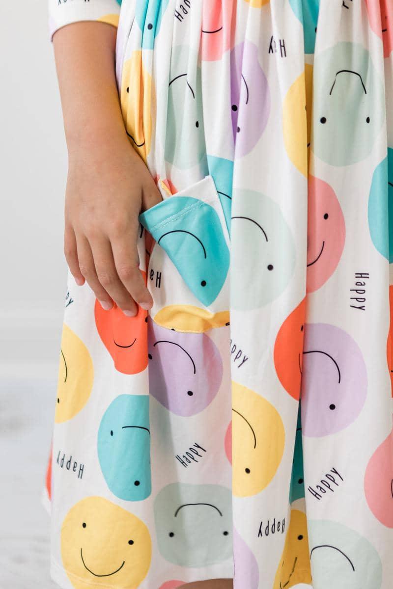  happy face pocket twirl dress for girls with colorful smiley face print and 3/4 sleeves