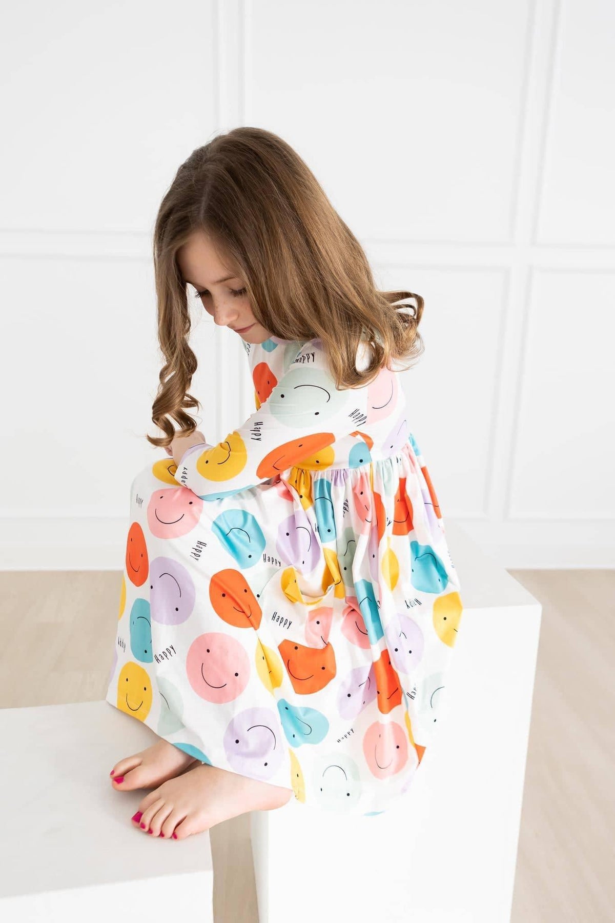  happy face pocket twirl dress for girls in white with colorful smiley faces, sleeved, toddler size