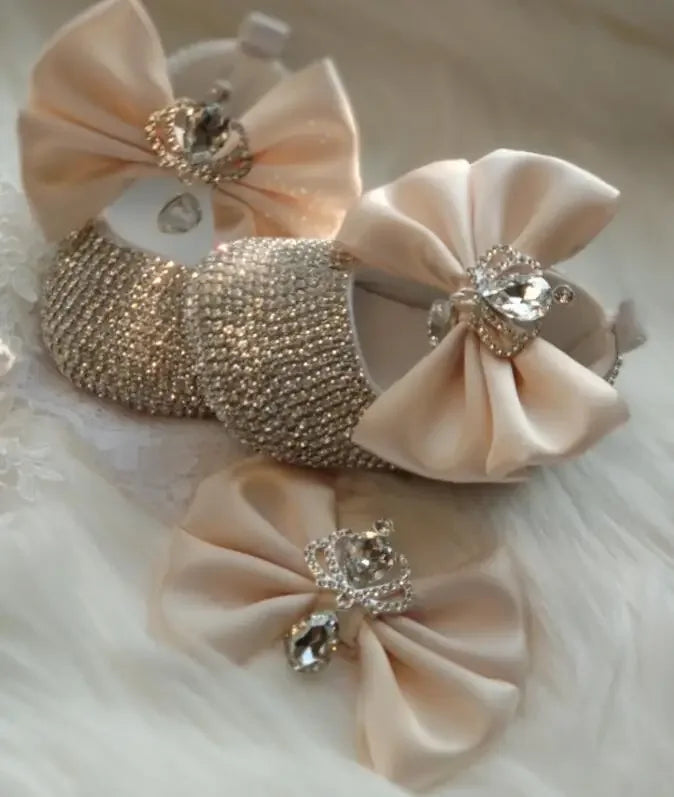 Elegant beige headpiece set for babies with large bows and sparkling rhinestone crown details