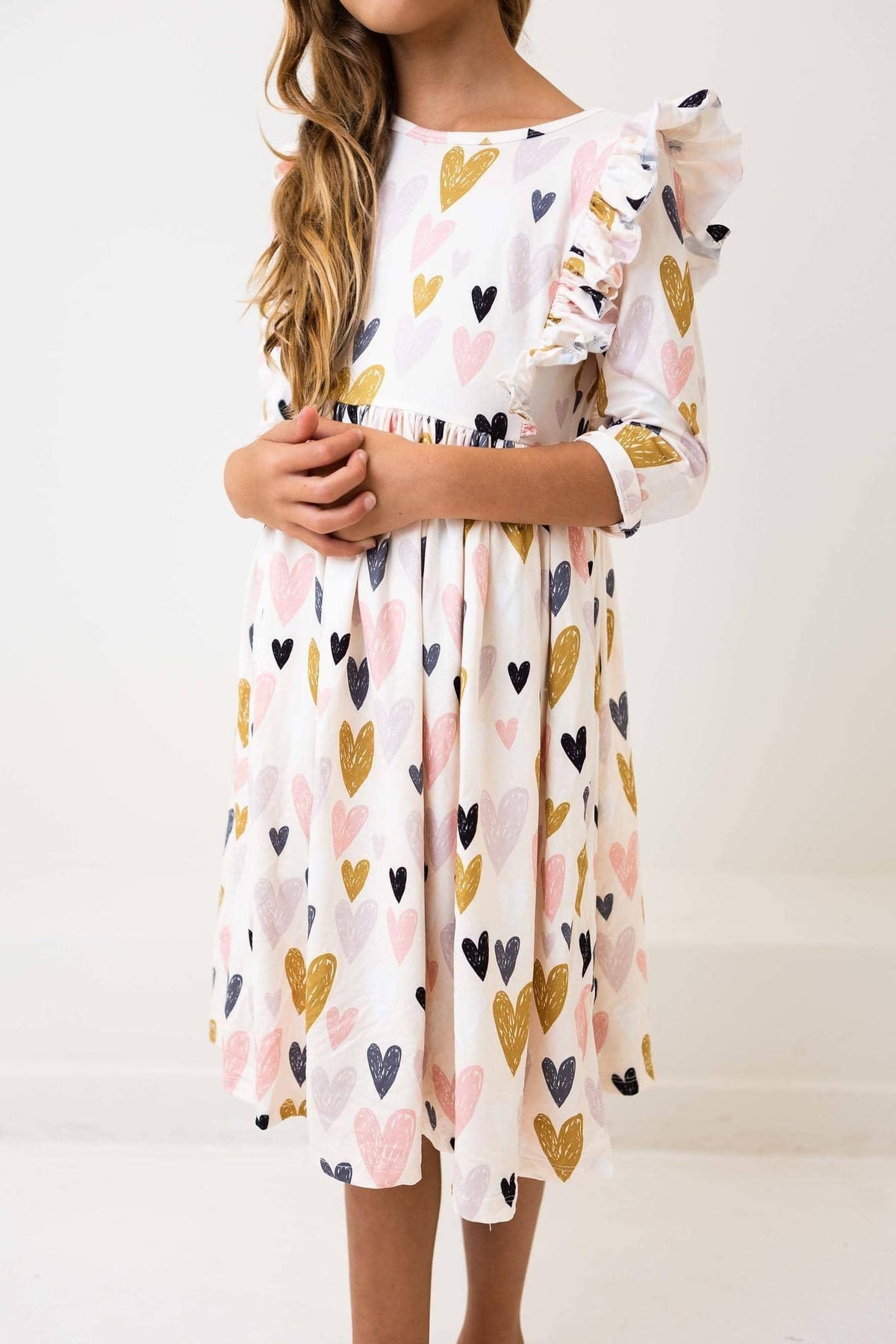 Young girl wearing white heart print ruffle twirl dress by 