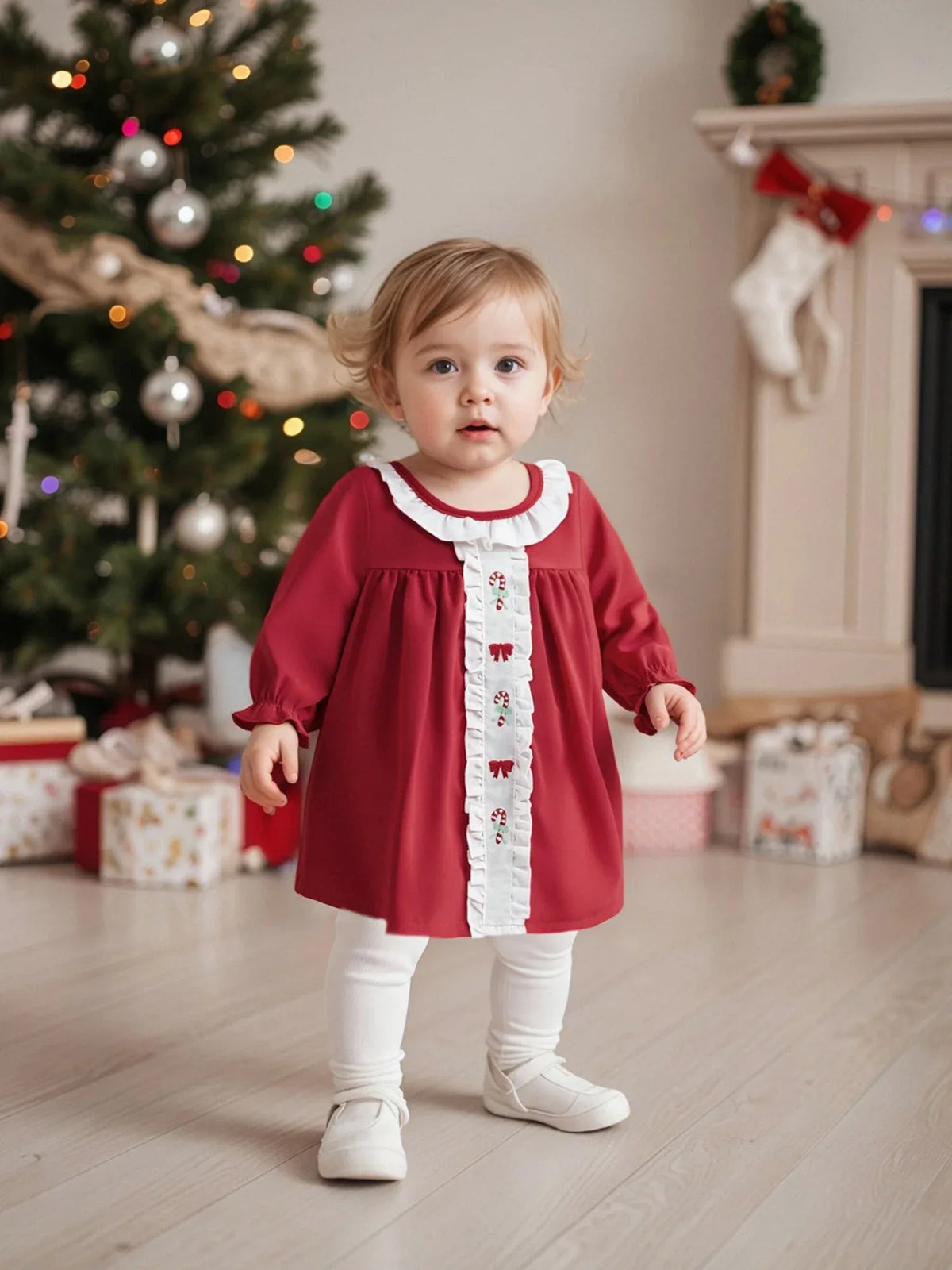 Red holiday baby dress with candy canes for toddlers featuring white ruffled collar and long sleeves