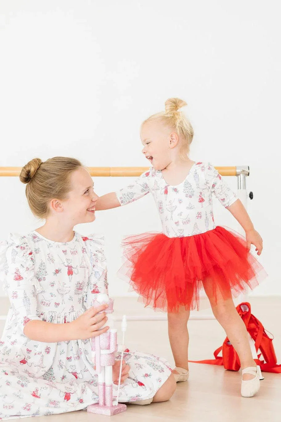 Holiday red tutu leotard for girls with 3/4 sleeves worn by toddler with blonde hair