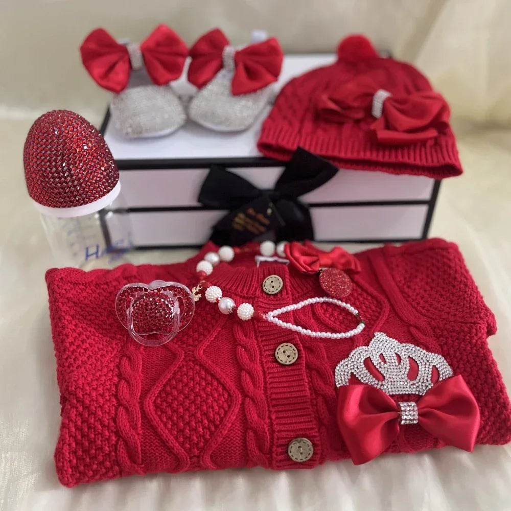 Red knitted homecoming baby outfit set for newborns with crown detail and matching hat with bow
