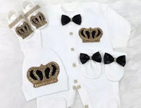 white homecoming baby outfit set with black and gold crown details, black bows, and matching hat and booties for newborns