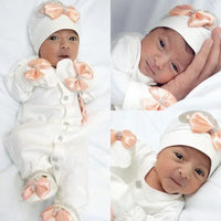 White homecoming baby outfit set for newborns with peach satin bows and rhinestone accents
