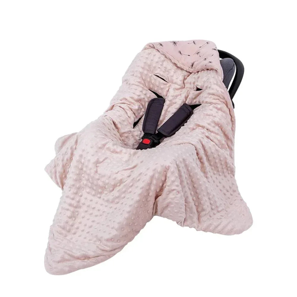 Light pink ultra soft baby swaddle blanket made of plush minky fabric covering infant car seat