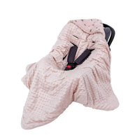Light pink ultra soft baby swaddle blanket made of plush minky fabric covering infant car seat
