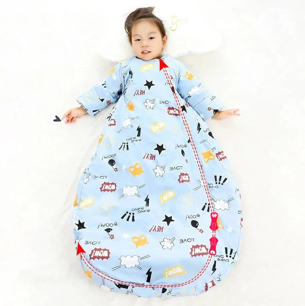 toddler boy lying down wearing light blue zippered sleeping bag for kids with comic print