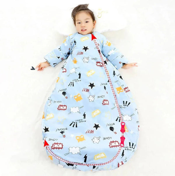toddler boy lying down wearing light blue zippered sleeping bag for kids with comic print