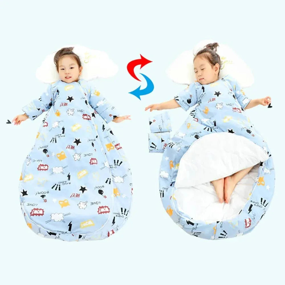 Toddler wearing blue zippered sleeping bag for kids with playful comic print lying on pillow