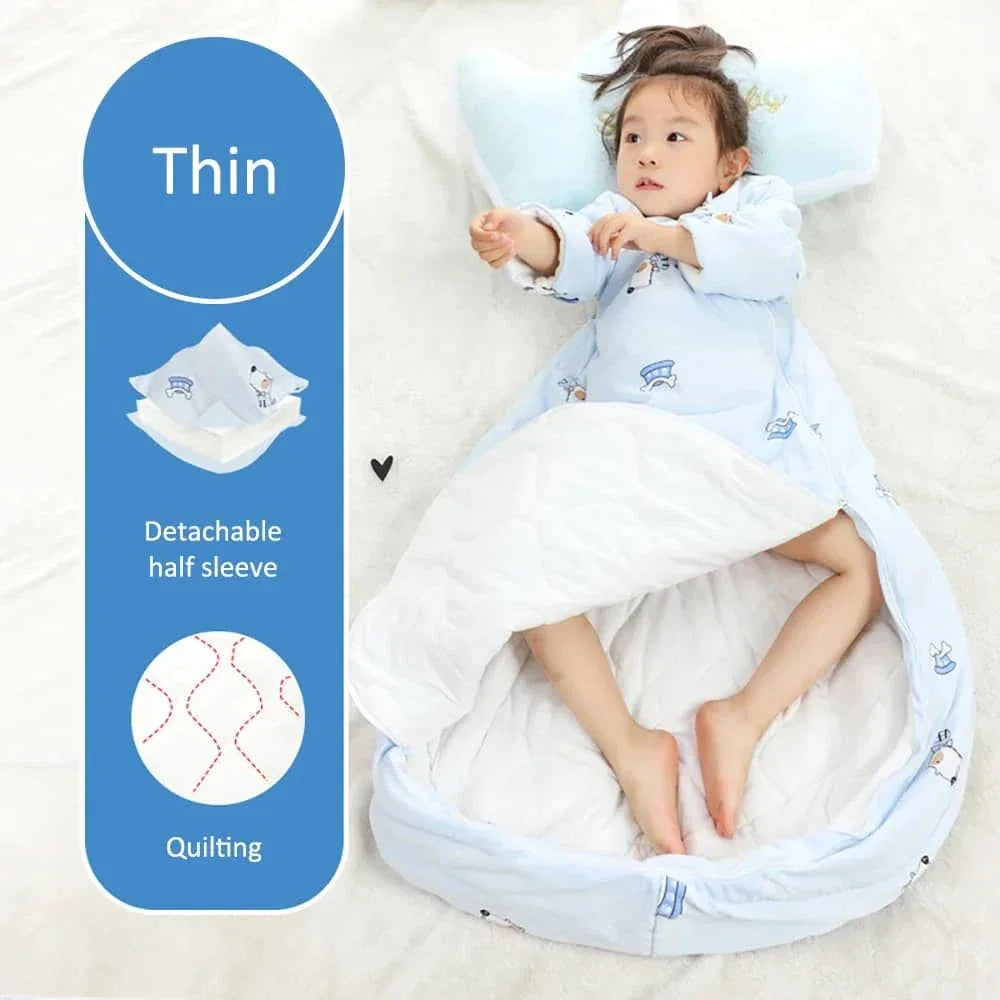 young child lying in blue zippered sleeping bag for kids with detachable half sleeve and quilting