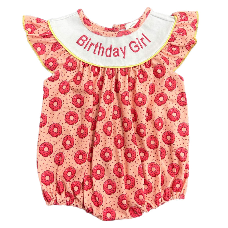 Close-up view of the 'Playful Donuts' birthday girl romper featuring a colorful donut pattern and 'Birthday Girl' text on a playful collar.