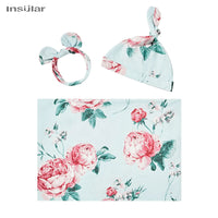 floral baby swaddle blanket set in light blue with pink flowers including newborn hat and headband