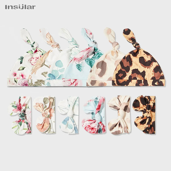 Floral baby swaddle blanket set with pink, blue, and brown patterns, includes matching knot hats for newborns