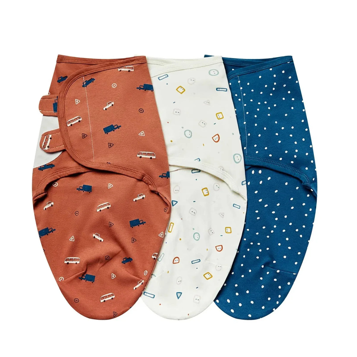 Set of cotton swaddle bags for babies in rust with vehicle prints, white with colorful shapes, and navy blue with white dots