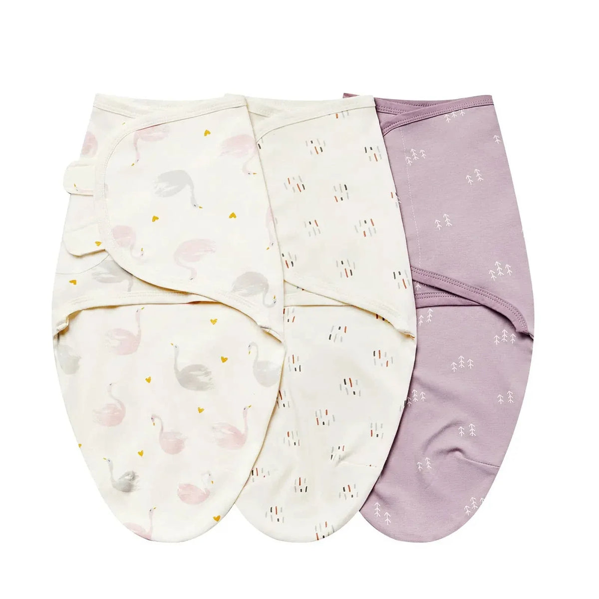 Set of three cotton swaddle bags for babies in pastel pink, cream with swan print, and white with small pattern