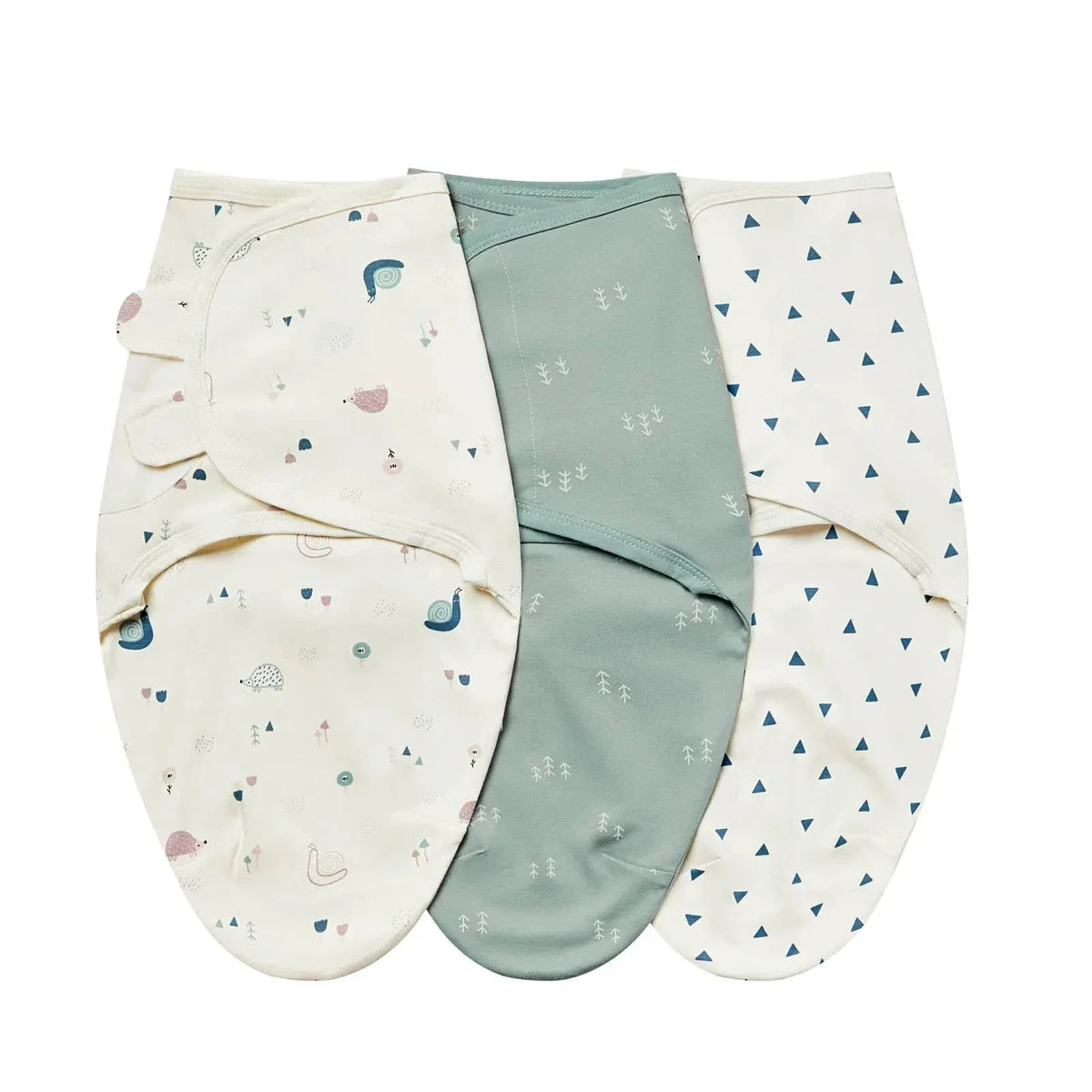 Set of three swaddle bags for babies in cream with animal prints, solid green, and white with blue triangles, made of soft cotton