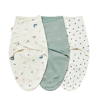 Set of three swaddle bags for babies in cream with animal prints, solid green, and white with blue triangles, made of soft cotton