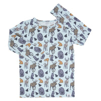 Light blue big kid pajama top featuring a forest animal print with moose, deer, bears, foxes, and ferns.