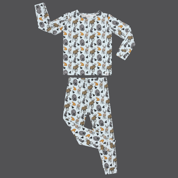 Into the Wild big kid pajama set featuring moose, bears, deer, and foxes on a light blue long sleeve top and pants.