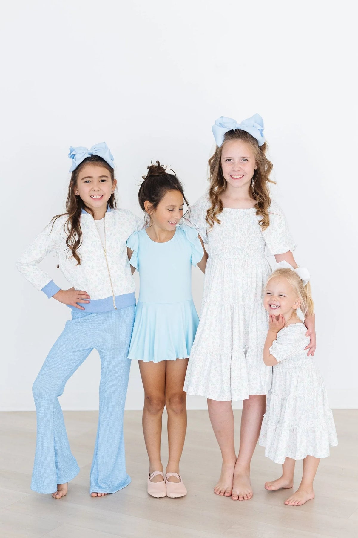 Girls white satin jacket for girls with blue trim, long sleeve, worn by children of various ages
