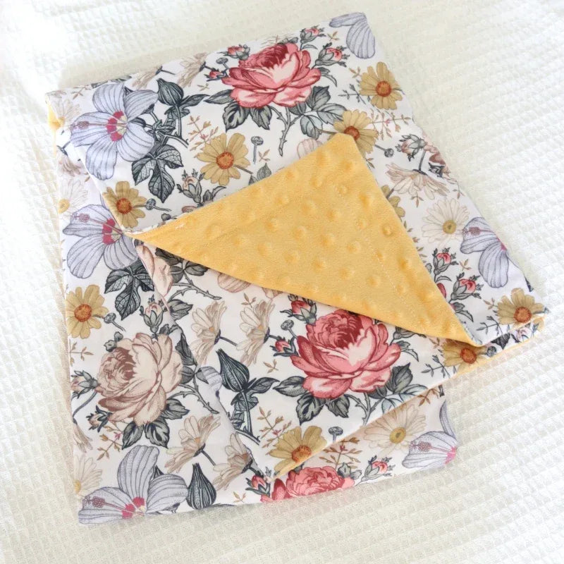 cozy fleece baby blanket for babies with floral print and mustard yellow textured reverse