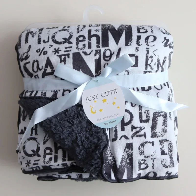 black and white cozy fleece baby blanket with alphabet print and soft sherpa lining for infants