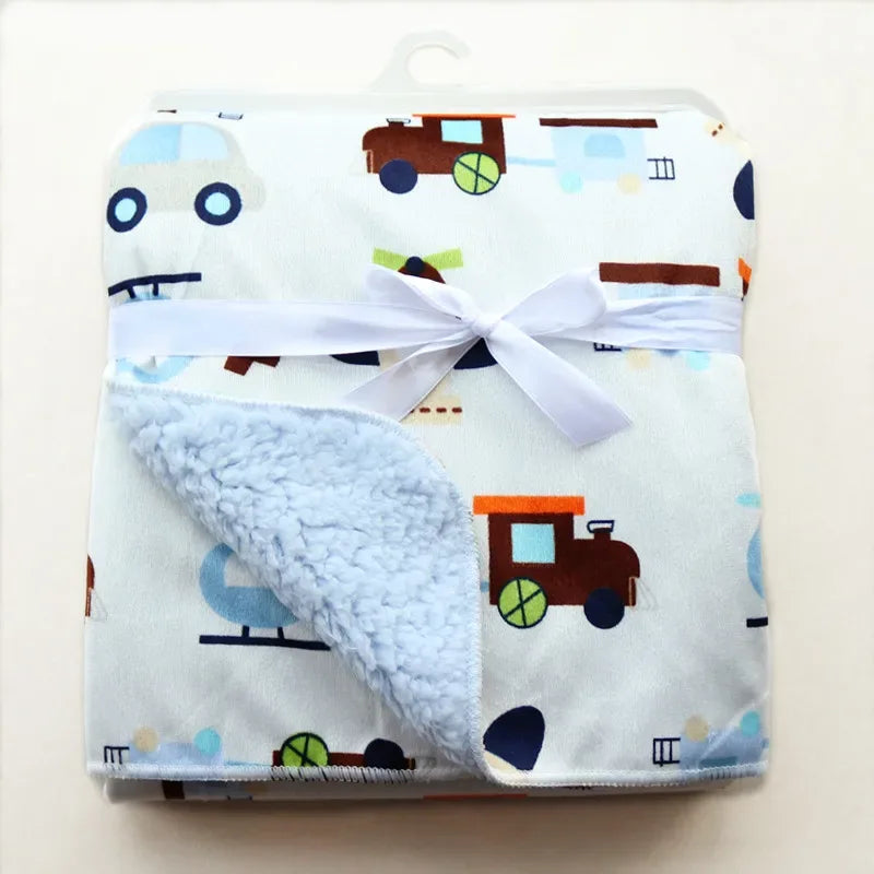 Cozy fleece baby blanket with blue vehicle print and soft light blue fleece lining for infants