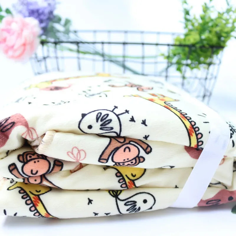 cream cozy fleece baby blanket for infants with colorful animal prints including monkeys and birds